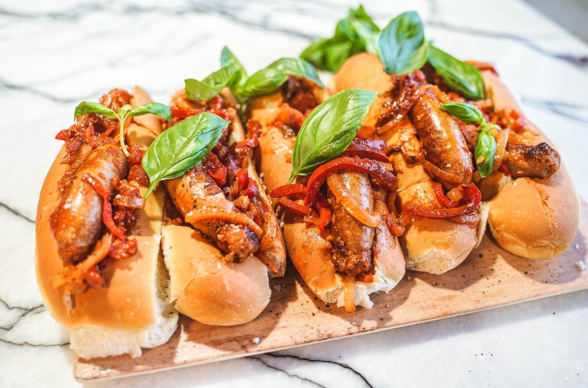 Pork & Fennel Sausages with Sautéed Capsicum & Onion in our house baked Roll